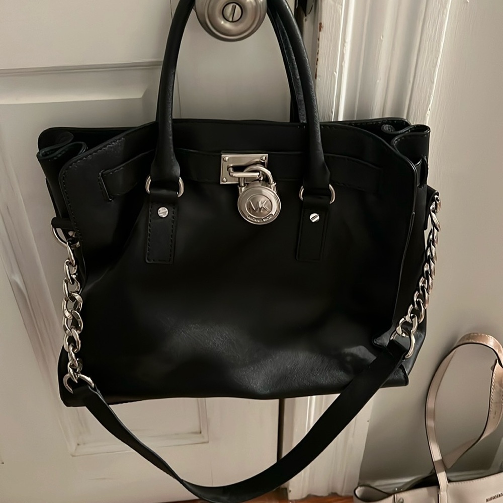 Black and silver Michael Kors bag and wallet.